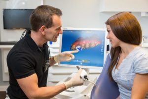 dentist showing a patient a digital model of CEREC dental crown