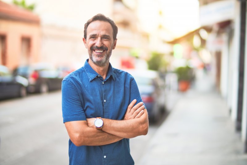 mature man smiling after undergoing cosmetic dentistry