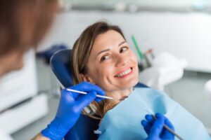 Woman smiling in dentist's chair having a checkup.