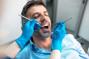 Patient being worked on by dentist during checkup.